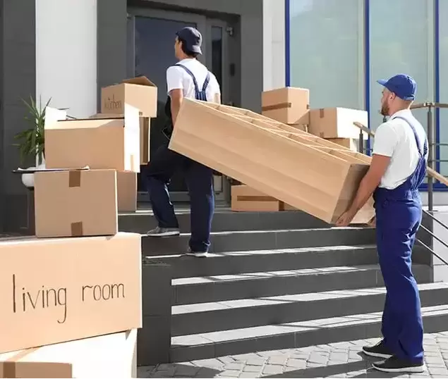 Two moving professionals carrying a piece of furniture